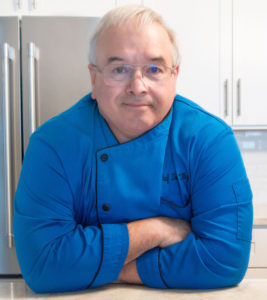 Chef Dennis Littley in blue chef coat