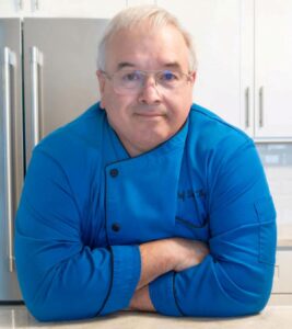 Chef Dennis Littley in blue chef's coat